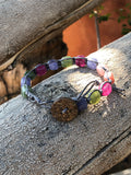 Grey thread bracelet with green, purple and pink stones