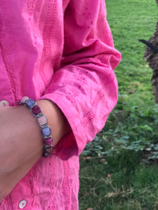 Grey thread bracelet with green, purple and pink stones