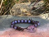 Brown thread bracelet with purple stone