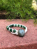 White thread bracelet with green stone