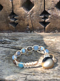 Golden thread bracelet with sky blue and light brown stone