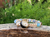 Golden thread bracelet with sky blue and light brown stone