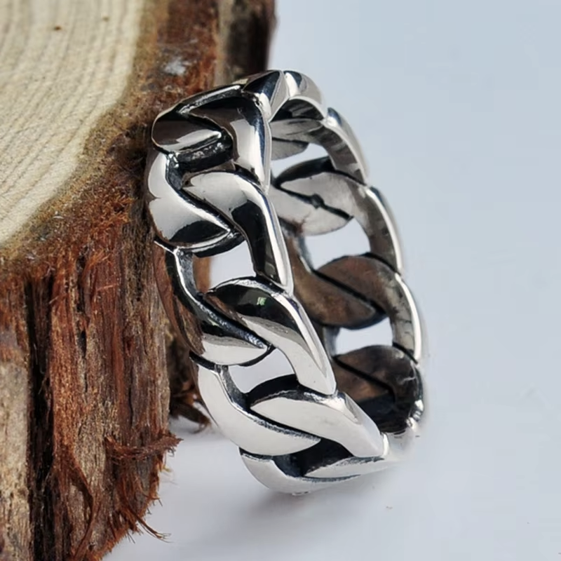 Silver chain ring on a wooden surface