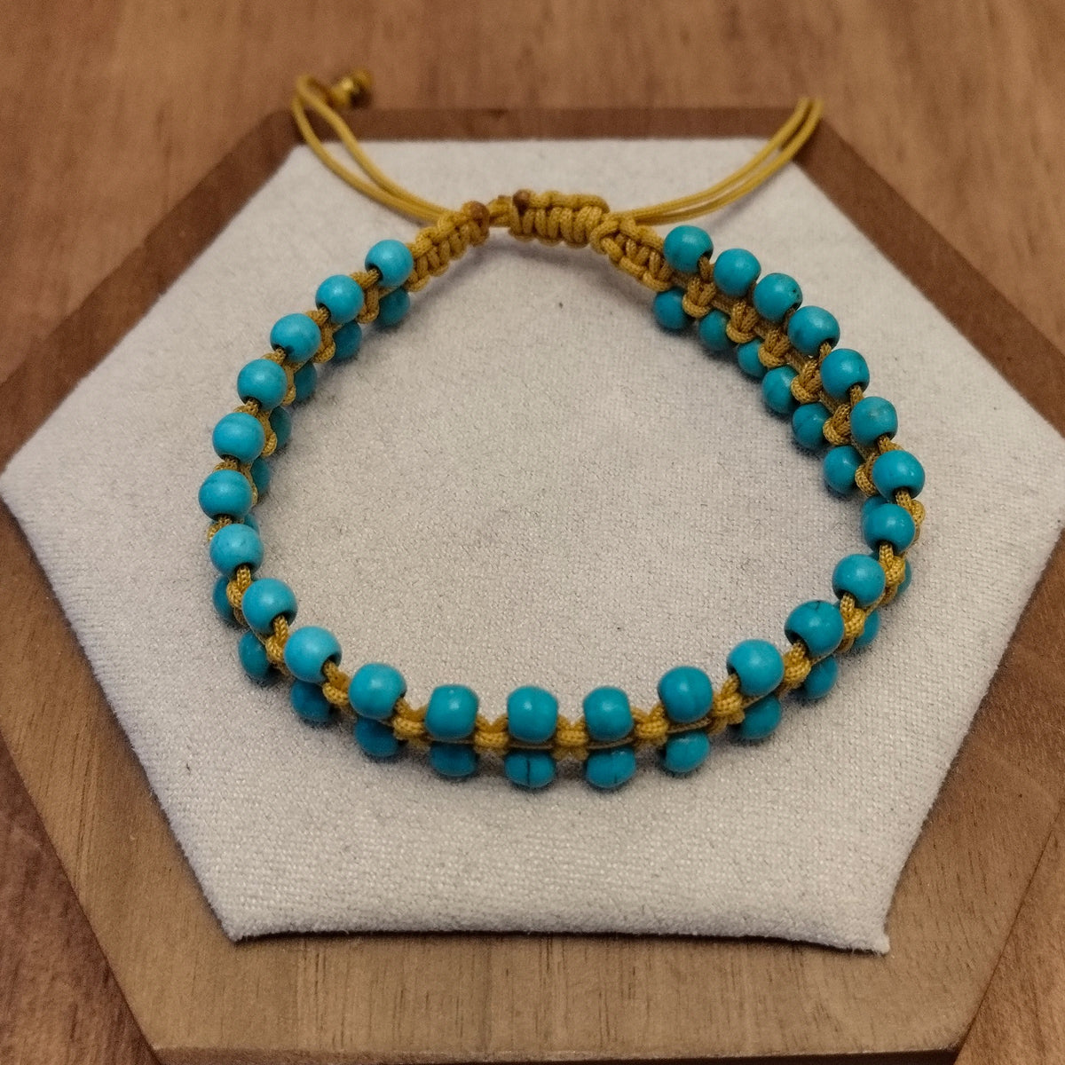 A bracelet of small turquoise beads with a macrame clasp-12039