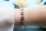 A sterling silver bracelet with four roses. Length: 18 cm + 5 cm extension