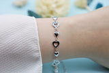 A sterling silver bracelet with hollow and solid hearts. Length: 18 cm + 5 cm extension